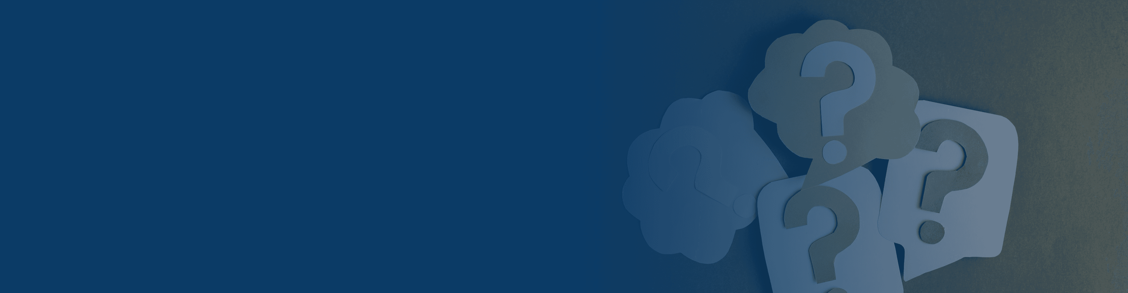 A smiling vendor packing a box on a shelf filled with packages.